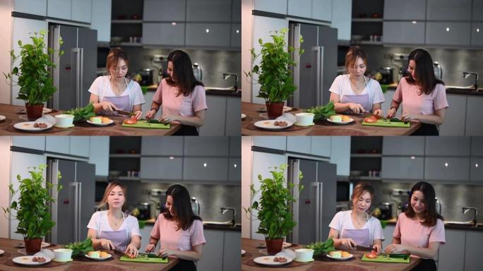 2位亚洲华人姐妹在餐厅里度过了亲密的时光，准备早餐食物快乐地交谈