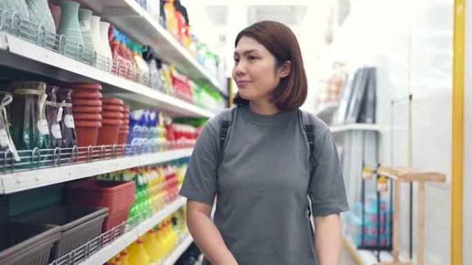 女人在超市里用杂货店的购物车散步