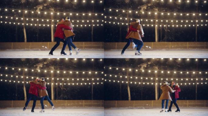 浪漫的冬天下雪的夜晚: 滑冰夫妇在溜冰场上玩得开心，旋转，跳舞，跳跃。户外双人滑冰。年轻人的肖像，恋
