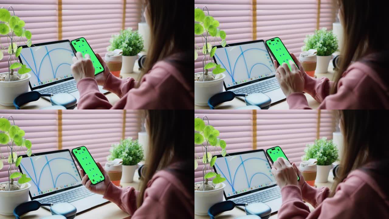 女人在桌子上使用电话绿屏