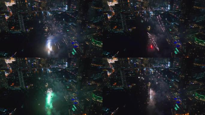 空中无人机视角多色烟花表演在天空之城。除夕。摩天大楼和城市景观庆祝夜晚的灯光