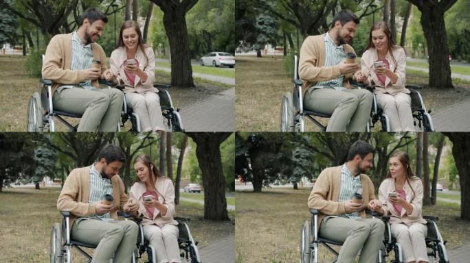 在公园里坐在轮椅上说话和使用智能手机的残疾年轻人的慢动作