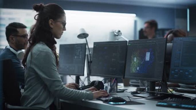 年轻的女性人工智能工程师在技术办公室从事计算机工作。年轻的专家为创新的大数据区块链项目编写软件代码。