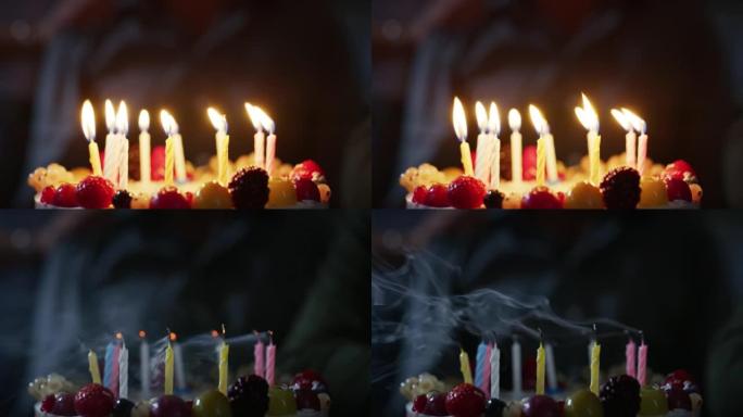在做梦后，生日人吹起生日蛋糕蜡烛的特写镜头。家庭、友谊、节日、庆祝、礼物的概念