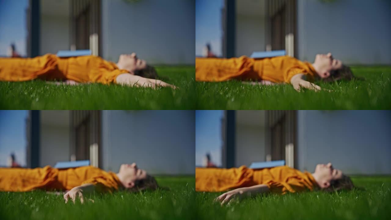 SLO MO年轻女子躺在后院的草坪上时碰到草