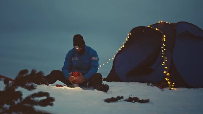 登山者在雪地上煮咖啡时会温暖双手