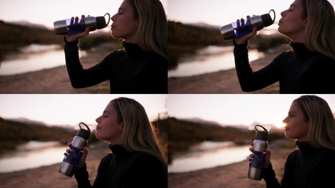 4k视频片段，一名年轻女子在外面喝水