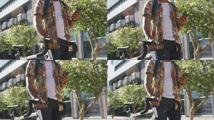城市中非裔美国人的中段，骑自行车并在街上使用智能手机