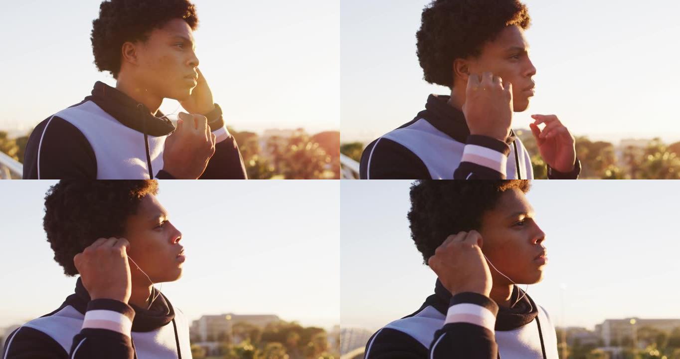 非裔美国人在海边户外运动时戴上耳机的特写镜头