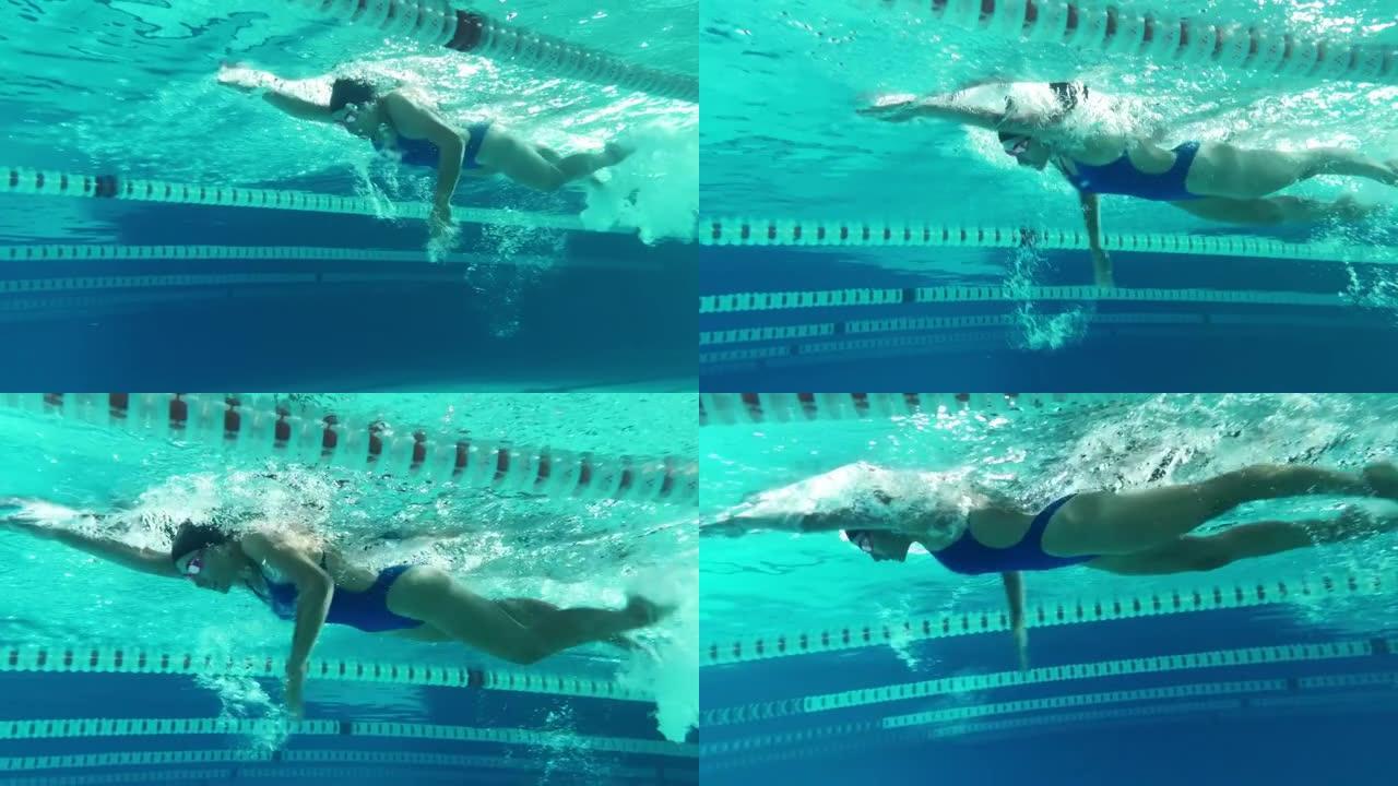 水下射击: 适合美丽的游泳者在游泳池里跑圈。职业女运动员以极快的速度游泳。准备创造世界冠军纪录。彩色