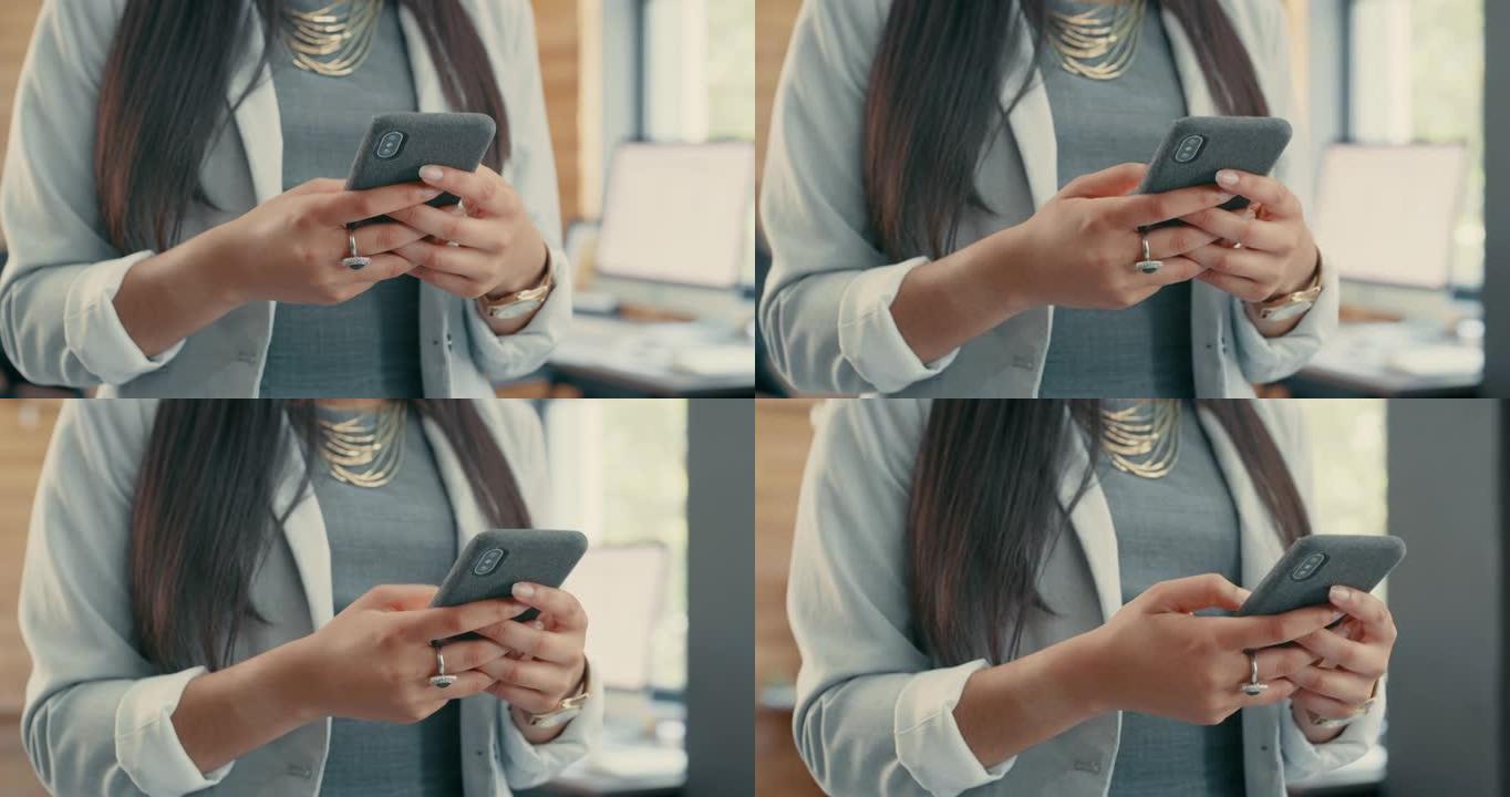 4k视频片段，一个无法辨认的女商人独自站在办公室并使用手机