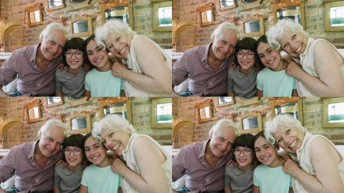 孙子坐在深情的祖父母之间的慢速视频肖像