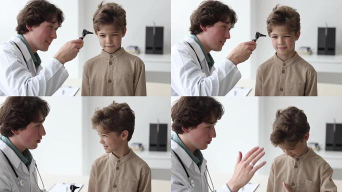 医生检查小男孩的耳朵，并击掌示意
