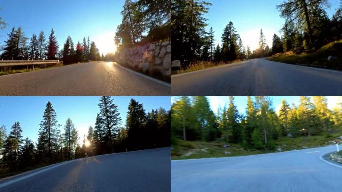 日落时美好的一天，在蜿蜒的山路上放松风景的汽车行驶