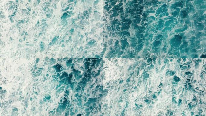 自上而下的鸟瞰图美丽的巨大蓝色海浪撞击和泡沫与白色洗涤背景