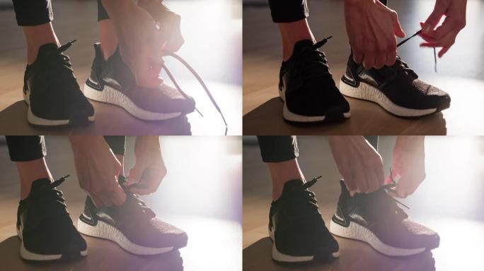 运动活跃的女人收紧运动鞋上的结，为晨跑做准备