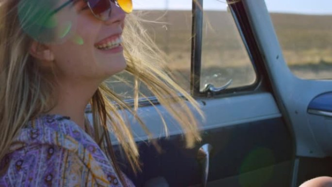 4k视频片段，一个开朗的年轻女子在汽车上行驶