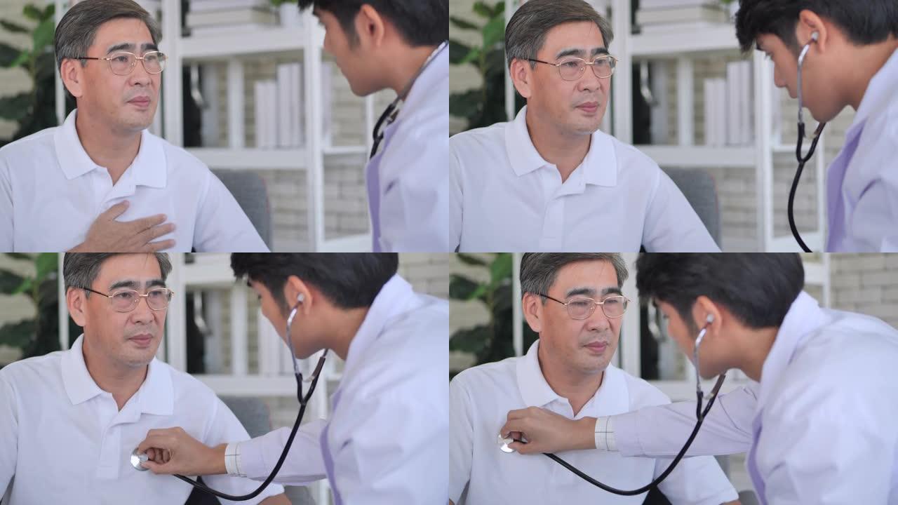 亚洲青年男护士医生检查心脏对54岁的亚洲老年男子预防流行病的同时咨询。男性医务人员概念。