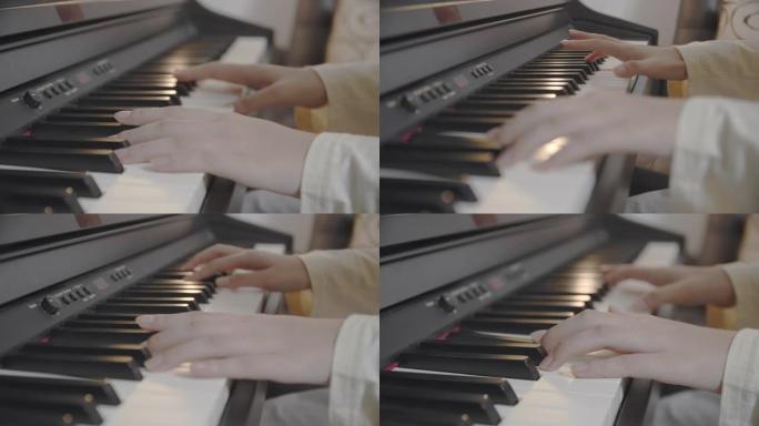 特写亚洲少年在家客厅弹键盘钢琴。美丽的女孩钢琴家在社交媒体上直播时弹钢琴。网络影响者Vlog或互联网