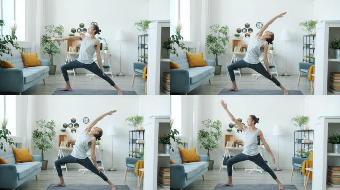有经验的运动员在家做瑜伽的肖像专注于锻炼