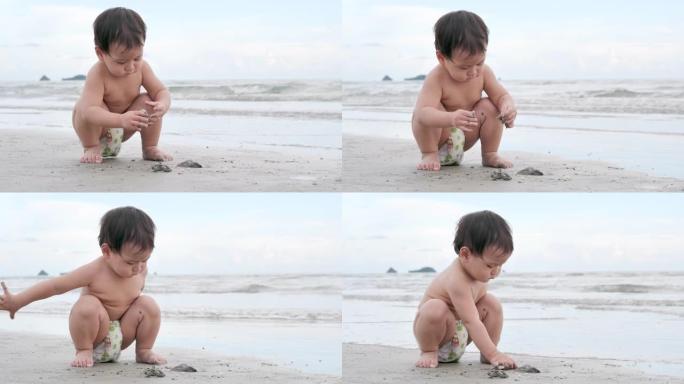 快乐的亚洲小男孩儿子学习在热带海滩上散步，在沙滩上沿着日落冲浪的边缘玩得开心。