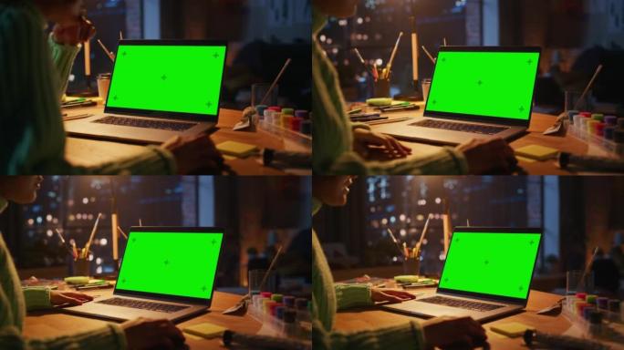 巴西女设计师在绿屏笔记本电脑上工作的特写镜头。女人在创建新项目时使用电脑鼠标。自由职业者和千禧一代的