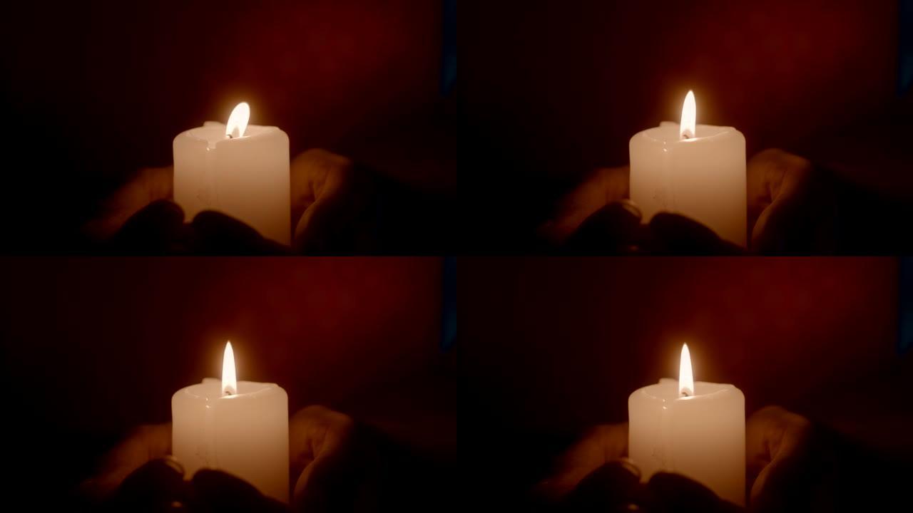 双手在黑暗中燃烧蜡烛