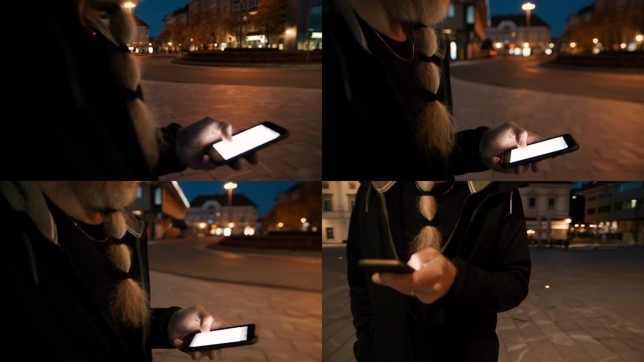 时髦女士晚上在城市使用智能手机