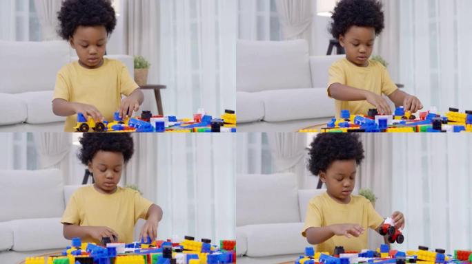 肖像2-3岁的小男孩的非洲种族在家上学时玩五颜六色的玩具积木呆在家里，以防止家庭生活中冠状病毒或Co