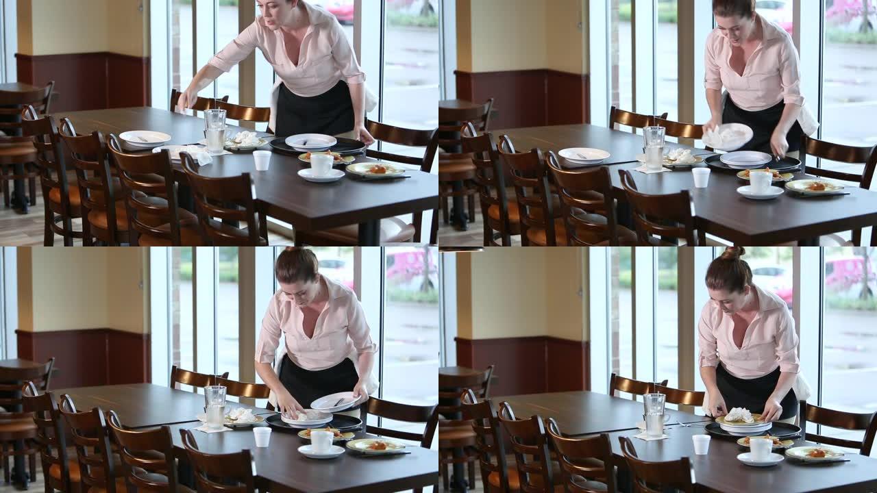 西班牙裔女服务员在餐厅工作，清理桌子
