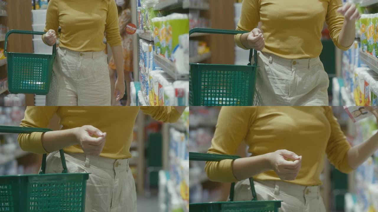 亚洲女孩在当地超市散步和选择食物。