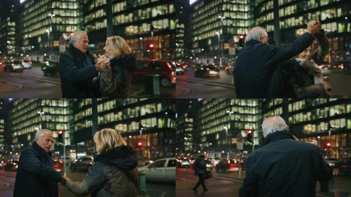 可爱的高级夫妇的特写镜头正在晚上在市中心跳舞庆祝他们永远的爱。