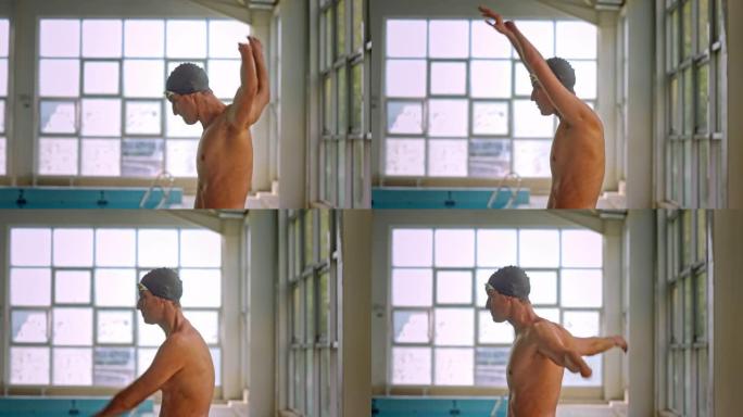 运动员游泳运动员在室内游泳池中的手臂热身