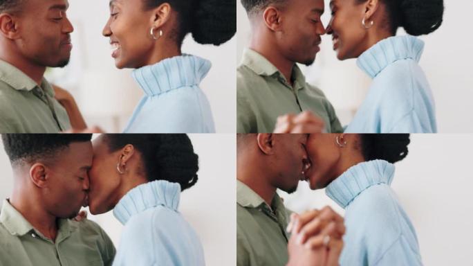 爱情和幸福的夫妇在家里一起亲吻庆祝、婚姻成功或情人节纪念日。幸福，关怀和浪漫的黑人，男人和女人在约会