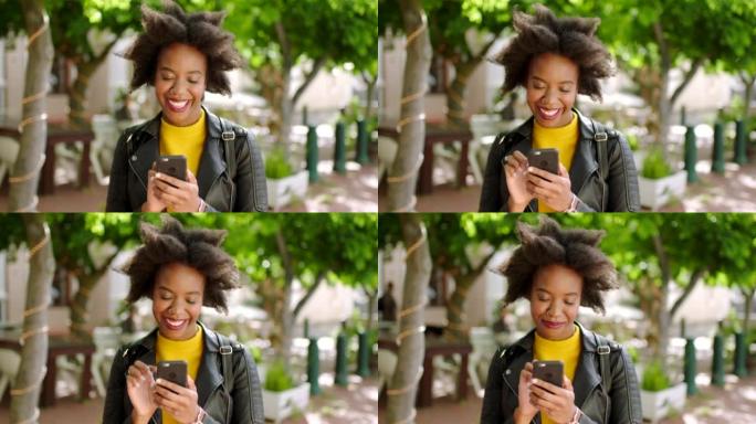 一名黑人妇女在公园户外使用手机在社交媒体上发短信。美丽的非洲女性与非洲在约会应用程序上聊天或回复短信