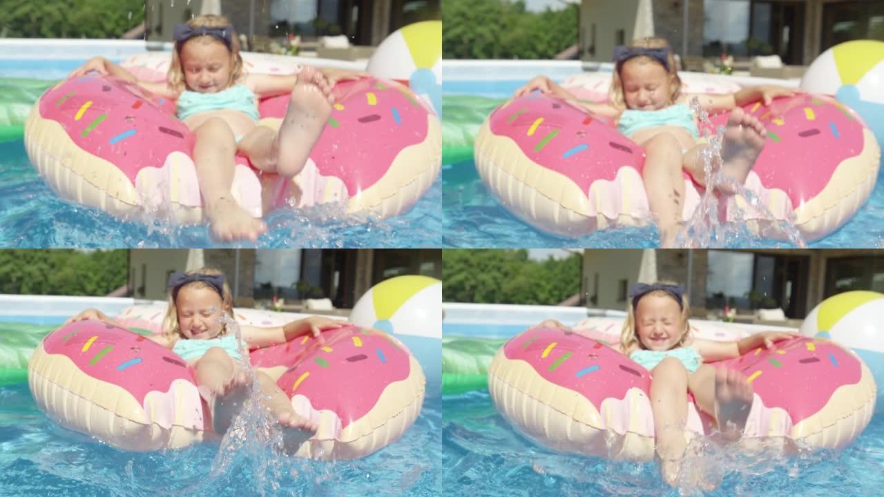 特写: 可爱的女孩漂浮在充气甜甜圈上的游泳池里，泼水
