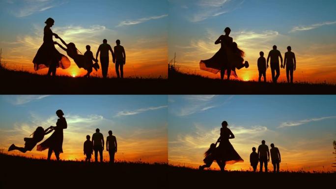 超级SLO MO的母亲在黄昏时与两个儿子在草地上散步时旋转女儿