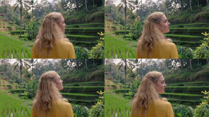 穿着黄色连衣裙的稻田美女享受假期探索通过印度尼西亚巴厘岛4k的水稻露台农场观光旅游