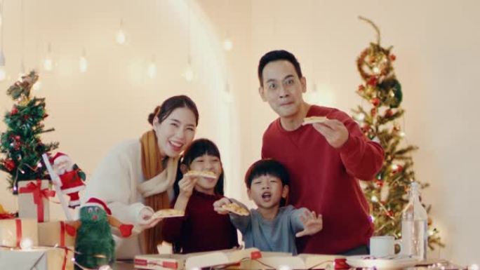 幸福家庭的肖像在家里的圣诞晚会上喜欢吃饭。