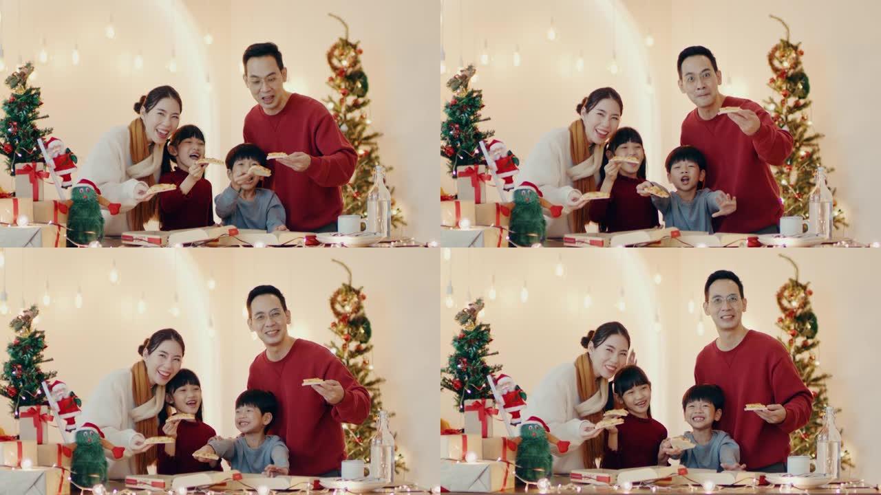 幸福家庭的肖像在家里的圣诞晚会上喜欢吃饭。
