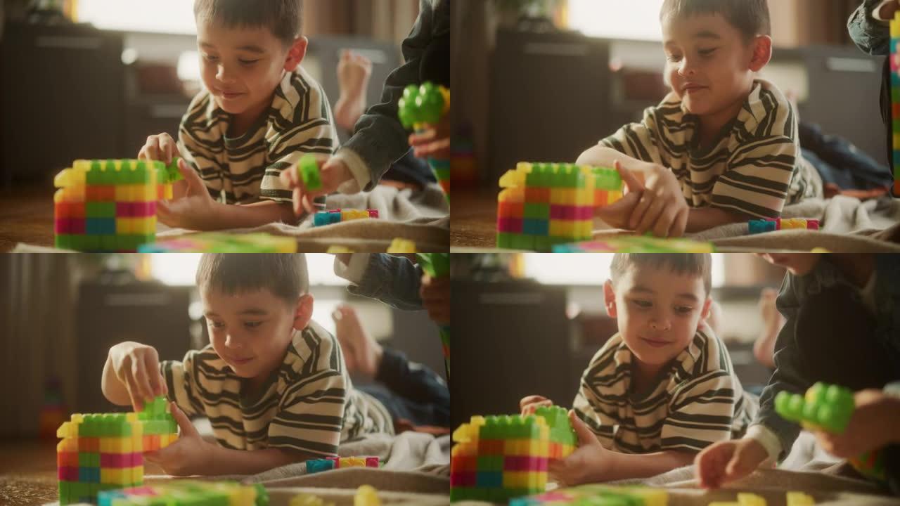 白天，可爱的亚洲男性孩子在房间里玩彩色积木的肖像。小男孩梦想成为未来的建筑师。他对自己的创作感到高兴