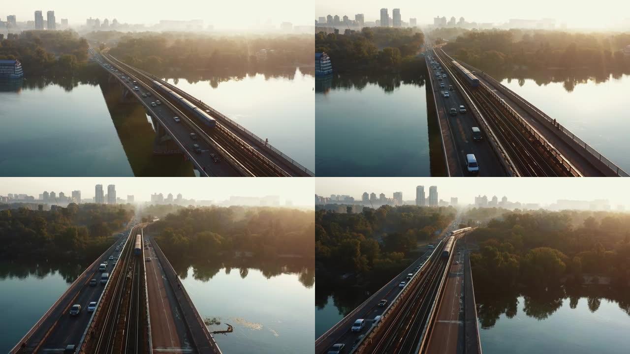 汽车和火车在令人惊叹的桥梁上穿越第聂伯河，田园诗般的空中天桥拍摄了乌克兰基辅的夏季日出。