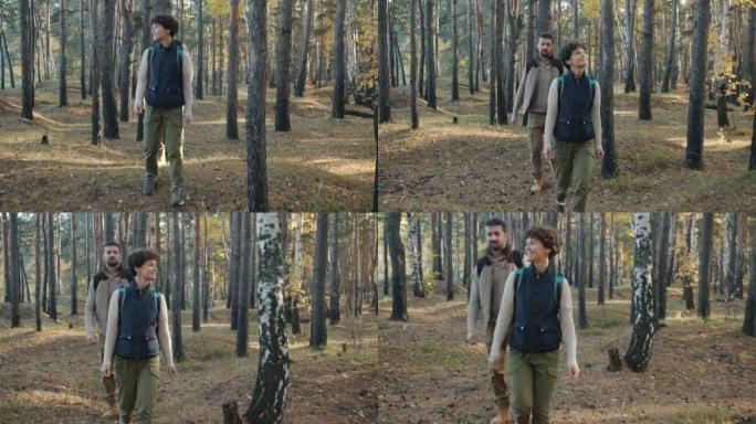 男人和女人背着背包在野林徒步旅行，微笑着享受假期