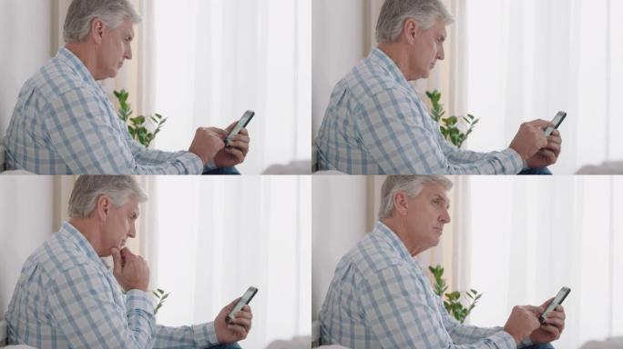快乐的成熟男人使用智能手机短信浏览社交媒体阅读短信享受手机上的数字通信在家放松4k镜头