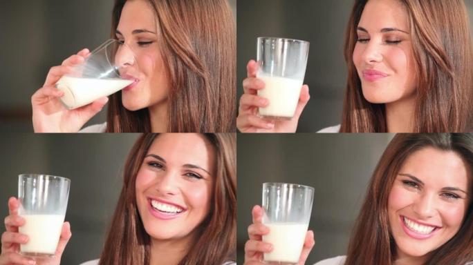 一名年轻女子在家中喝一杯牛奶的镜头