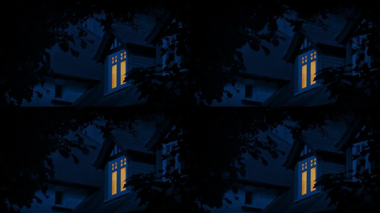 晚上卧室窗户上的灯被树木框住