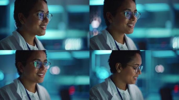 戴眼镜的美丽黑人拉丁女人迷人地微笑。在实验室工作的年轻聪明的女科学家。背景Bokeh蓝色，高科技技术
