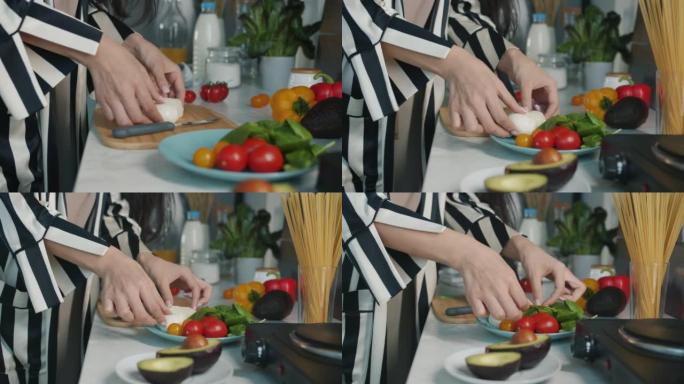 女性手切食物的特写在餐桌上的厨房里准备美味的饭菜