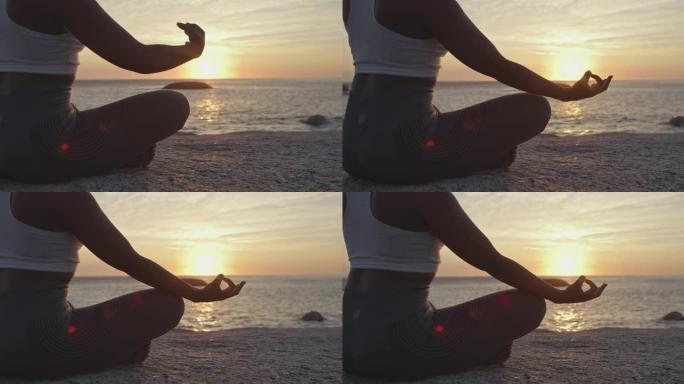 4k视频片段，一个无法识别的女人在海滩上做瑜伽