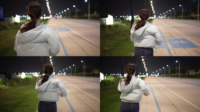 运动女人晚上跑步夜跑的女人马尾辫视频素材
